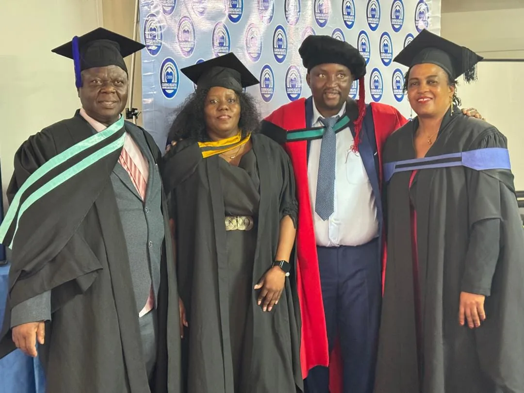 Caring Hearts faculty in academic dress at the graduation ceremony