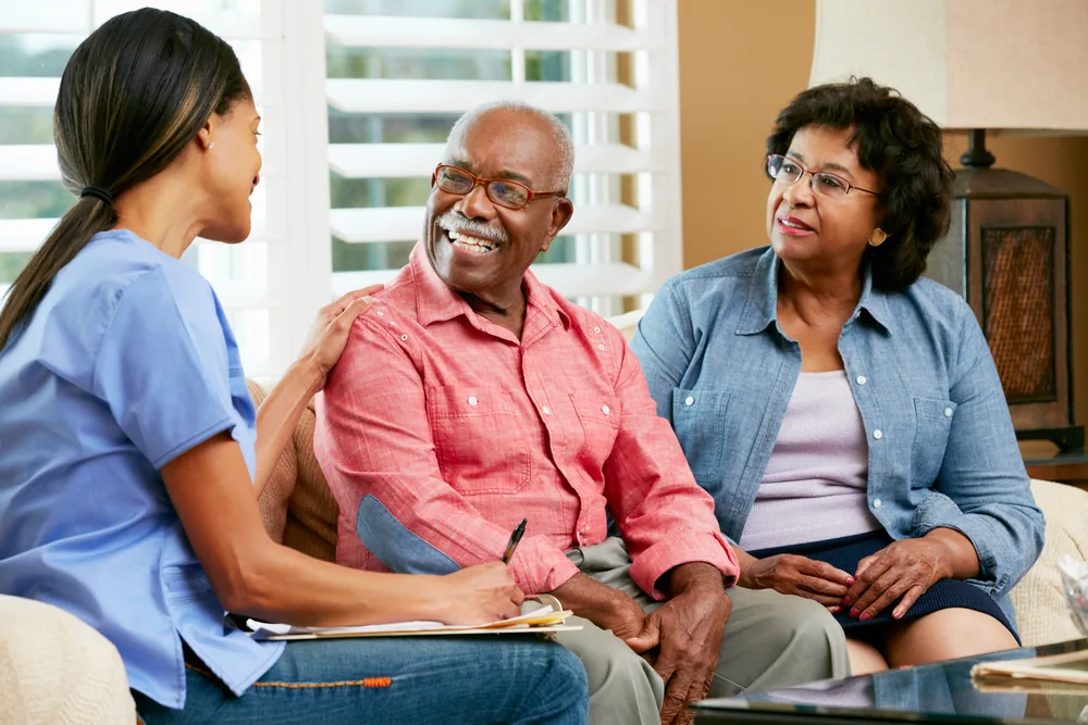 Nurse checking a client's blood pressure at home